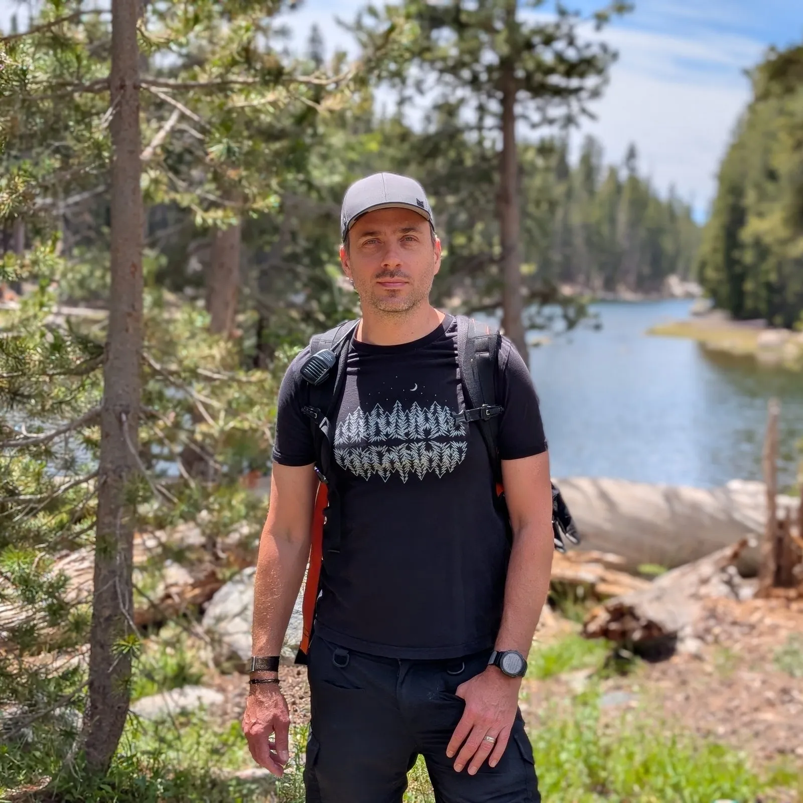 Dan Pupius in a cap and black t-shirt by an alpine lake in the Sierra Nevada.